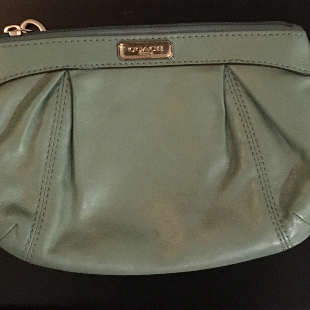A olive green coach wristlet